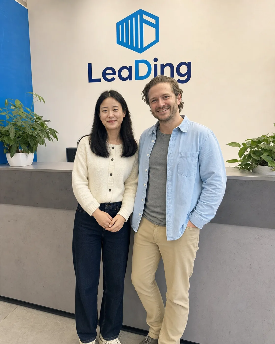 LeaDing representative and an international visitor in a reception area
