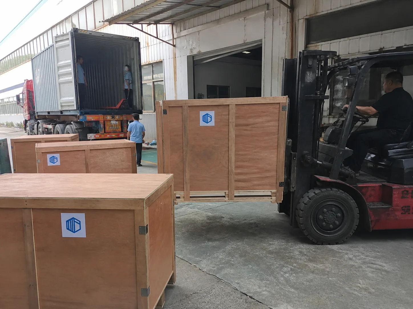 Large wooden export crates with LeaDing labels prepared at an industrial loading area