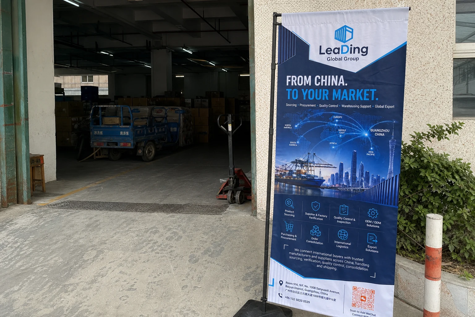 LeaDing Global Group fabric flag beside the entrance of a working warehouse in China